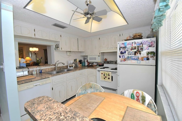 kitchen featuring white appliances, white cabinetry, a sink, and under cabinet range hood