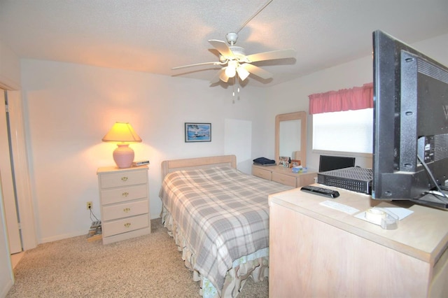 bedroom with a textured ceiling, a ceiling fan, and light colored carpet