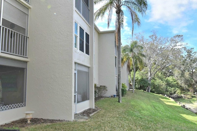 view of property exterior featuring a yard and stucco siding