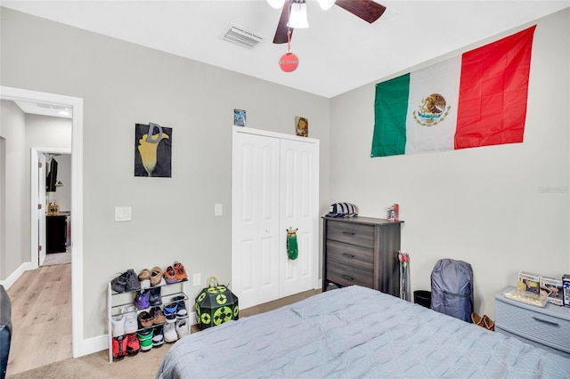 bedroom with ceiling fan and a closet