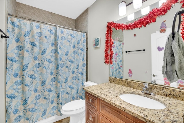 bathroom with vanity, curtained shower, and toilet