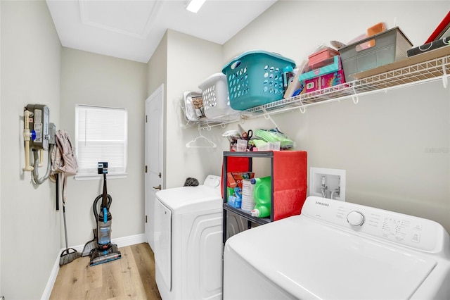 laundry area featuring hardwood / wood-style flooring and separate washer and dryer