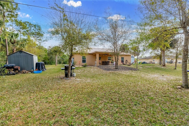 view of yard with a storage unit and a patio