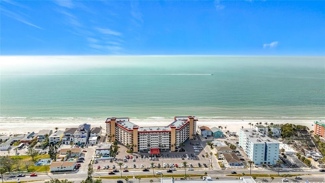 birds eye view of property featuring a beach view and a water view