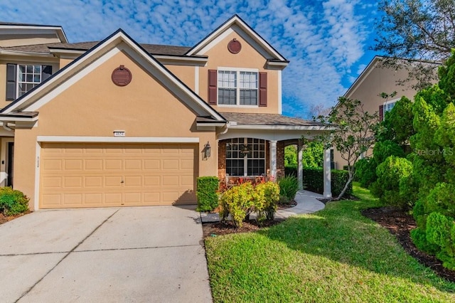 view of front of home with a front yard and a garage