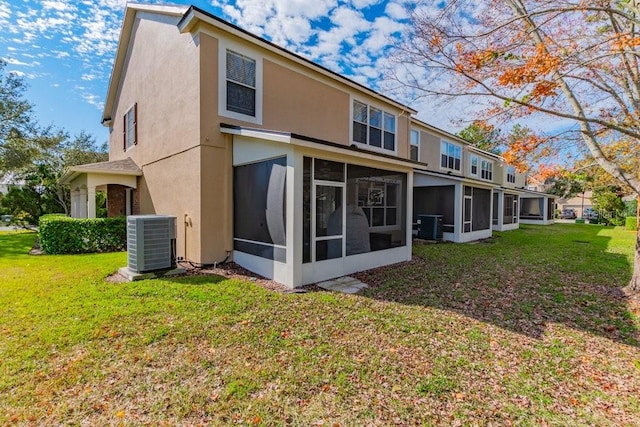 back of property with cooling unit, a lawn, and a sunroom