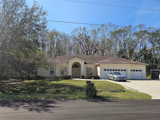 single story home featuring a garage and a front lawn