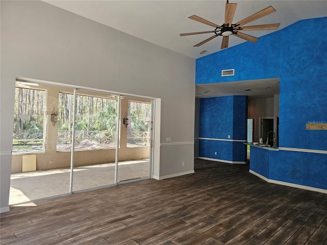 spare room with ceiling fan, high vaulted ceiling, sink, and hardwood / wood-style floors