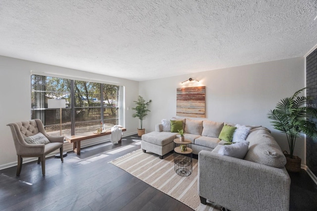 living room with dark wood-type flooring and a textured ceiling