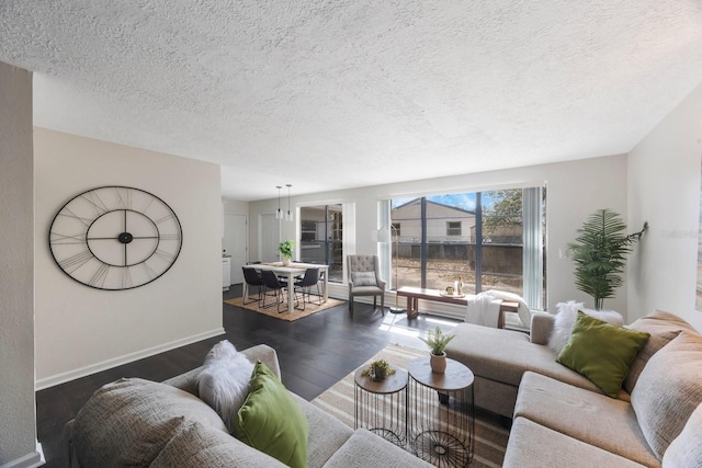 living room with dark wood-type flooring and a textured ceiling