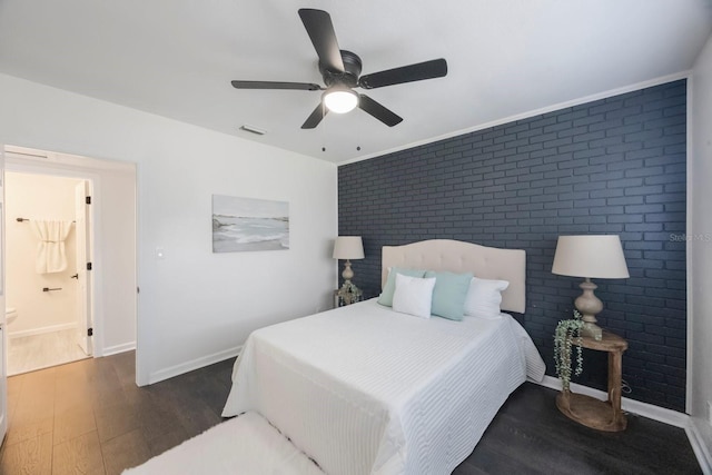 bedroom featuring brick wall, dark hardwood / wood-style floors, and ceiling fan