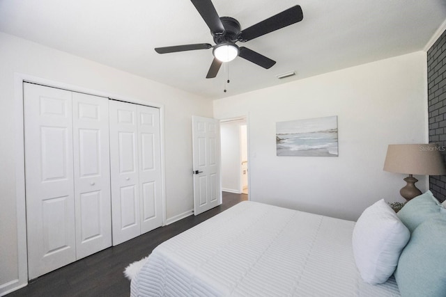 bedroom with a closet, dark hardwood / wood-style floors, and ceiling fan