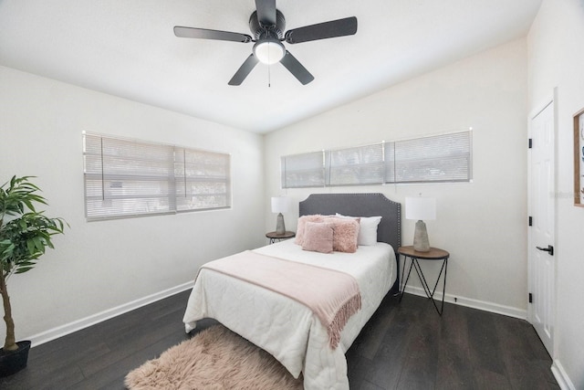 bedroom with dark hardwood / wood-style flooring, vaulted ceiling, and ceiling fan