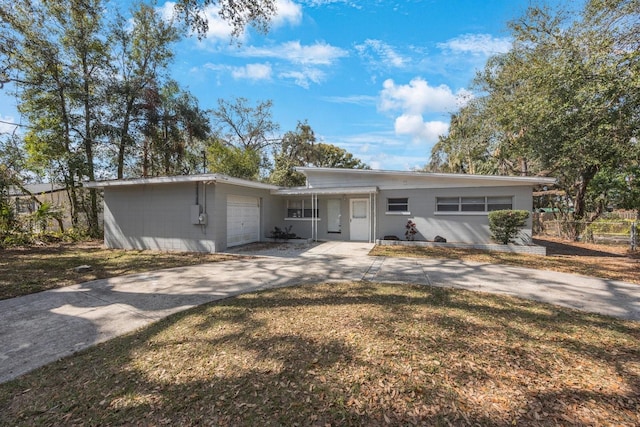 ranch-style house with a garage and a front yard