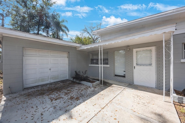 view of exterior entry with a garage