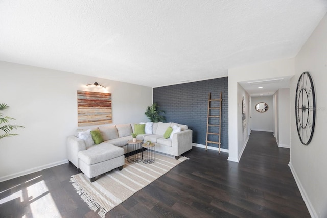 living room featuring dark hardwood / wood-style floors and a textured ceiling