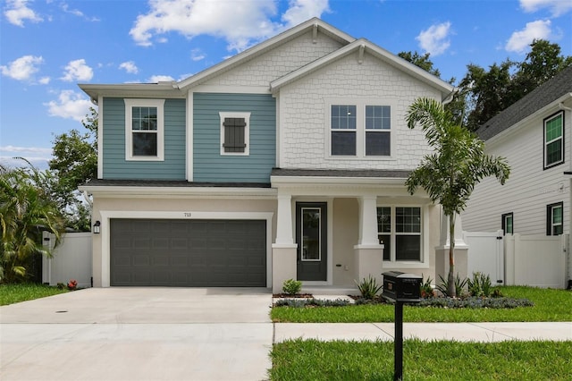 713 W W St, Tampa, FL 33603 - craftsman-style home with an attached garage, concrete driveway, and covered porch