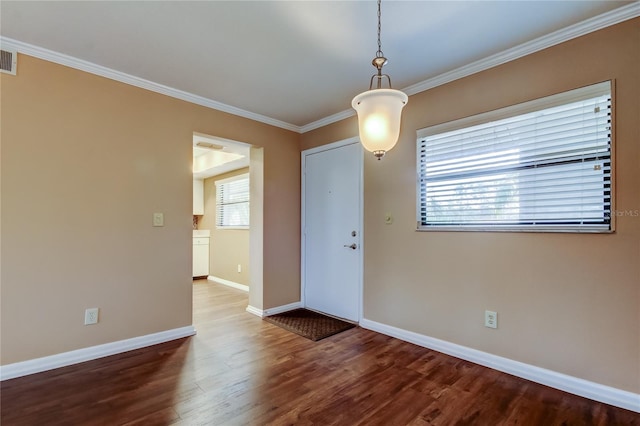 spare room with hardwood / wood-style floors and ornamental molding