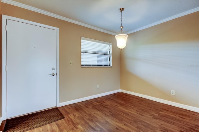 foyer entrance featuring crown molding and hardwood / wood-style floors