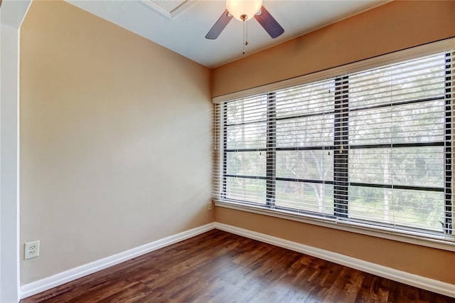 spare room featuring dark wood-type flooring and ceiling fan