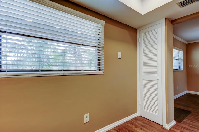 interior space featuring ornamental molding and light wood-type flooring