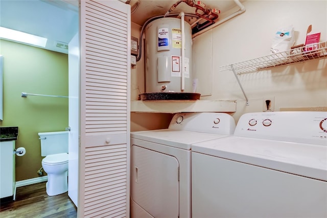 washroom featuring a skylight, wood-type flooring, electric water heater, and washing machine and clothes dryer