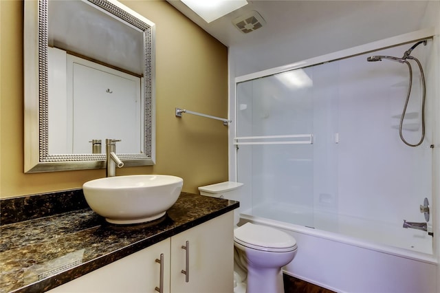 full bathroom featuring vanity, bathtub / shower combination, and toilet