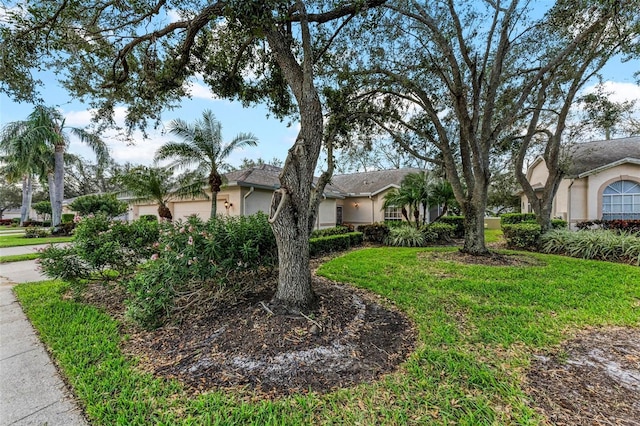 view of front of home featuring a garage and a front yard