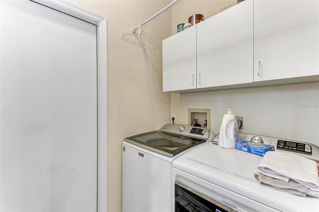 laundry area featuring cabinets and washing machine and dryer