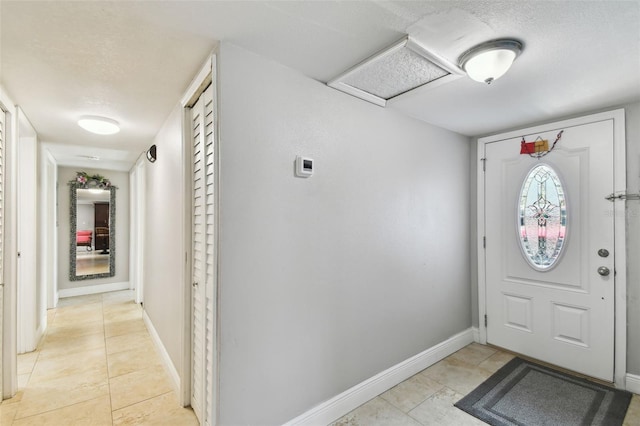 tiled foyer featuring a textured ceiling