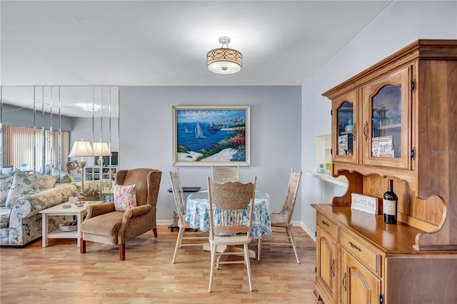 dining area featuring light wood-type flooring