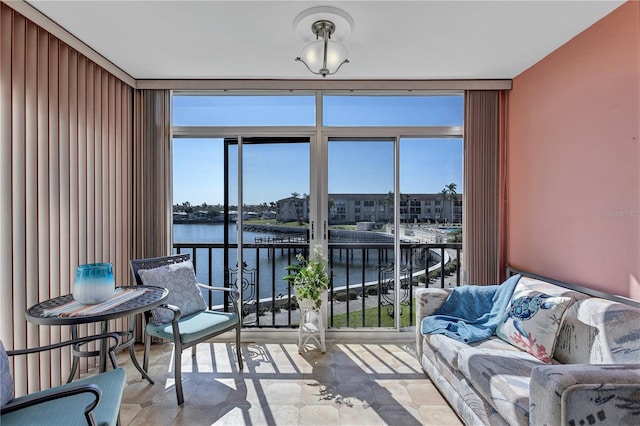 sunroom featuring a water view and a wealth of natural light