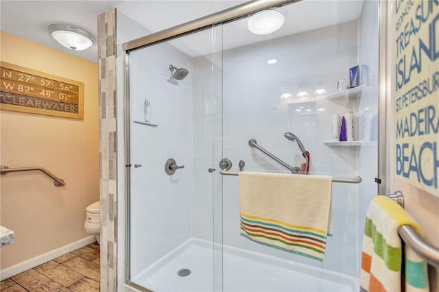 bathroom with toilet and an enclosed shower