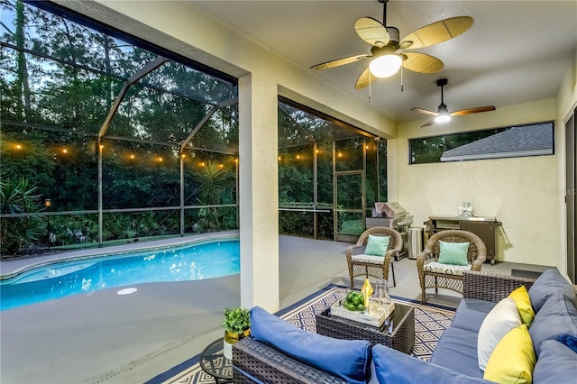 swimming pool featuring an outdoor living space, a patio, a lanai, and a ceiling fan
