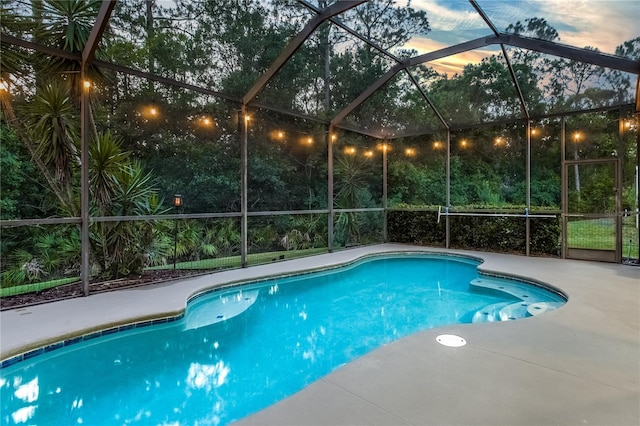 outdoor pool with a lanai and a patio area