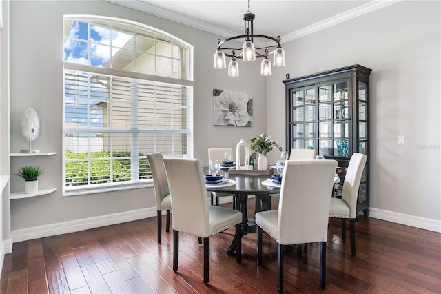 dining room featuring baseboards, a chandelier, hardwood / wood-style flooring, and ornamental molding