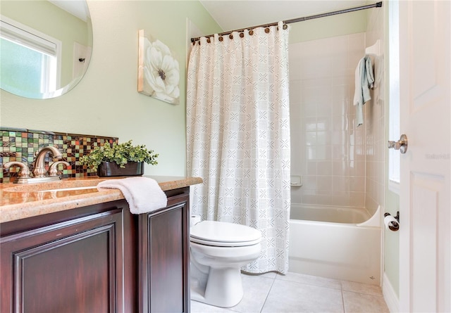 full bath with toilet, decorative backsplash, vanity, tile patterned flooring, and shower / bath combo