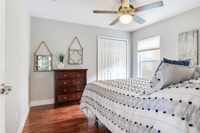 bedroom with wood finished floors, baseboards, a closet, and a ceiling fan