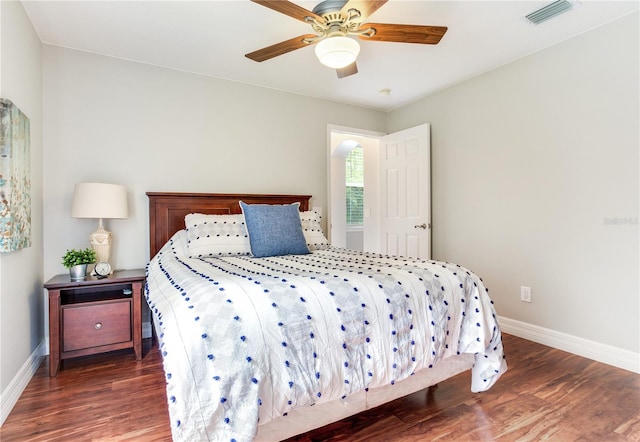 bedroom with baseboards, wood finished floors, and ceiling fan