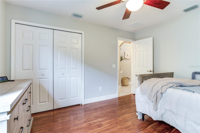 bedroom with wood finished floors, a closet, ceiling fan, and baseboards