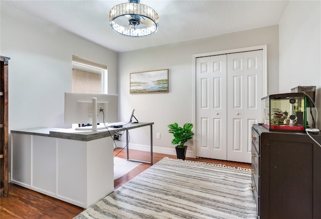 office featuring wood finished floors, a chandelier, and baseboards
