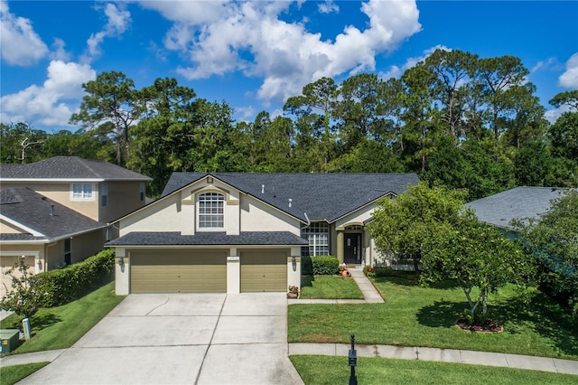 view of front of house featuring stucco siding, driveway, a front lawn, and an attached garage