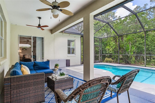 swimming pool with a patio, outdoor lounge area, and ceiling fan