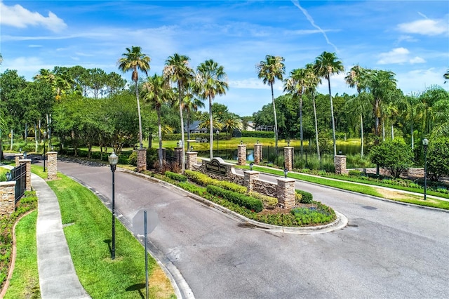 surrounding community featuring a water view and view of scattered trees