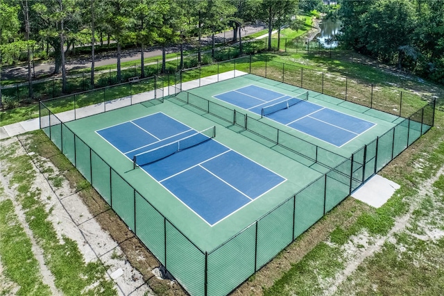 view of tennis court featuring fence