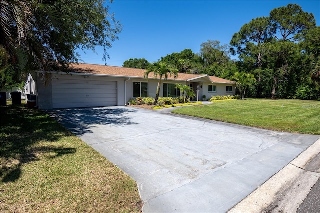 ranch-style house with a garage, driveway, and a front lawn