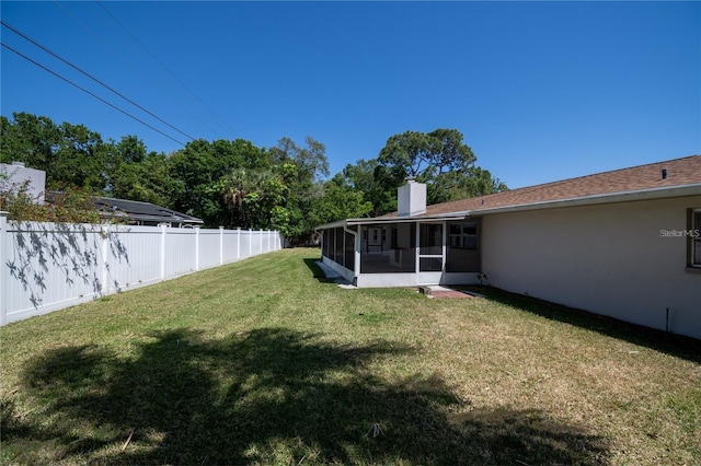 view of yard featuring a sunroom and fence