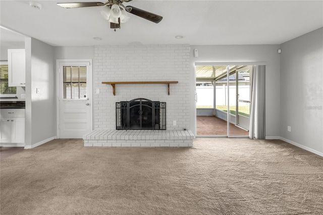 unfurnished living room with carpet floors, a fireplace, and baseboards