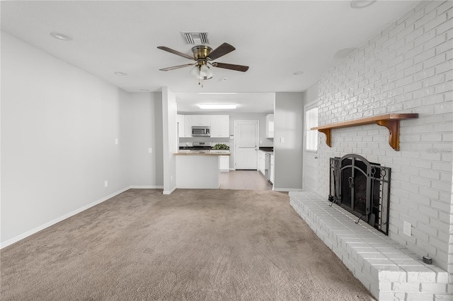 unfurnished living room featuring visible vents, a brick fireplace, light carpet, ceiling fan, and baseboards