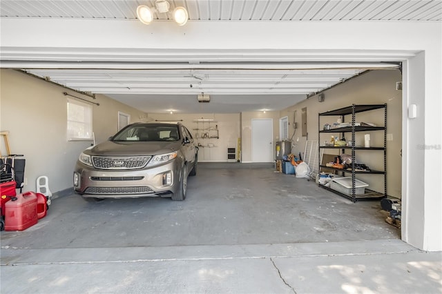 garage featuring electric water heater and a garage door opener